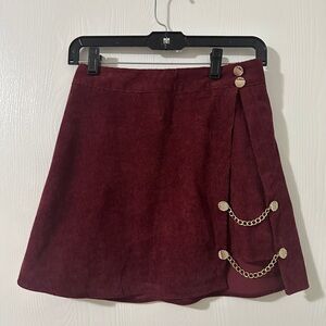 Merlot colored corduroy skirt with gold details on side.